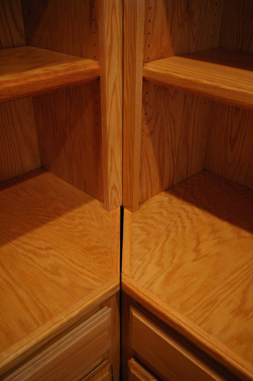 Close up of lower interface between center and side bookshelv