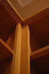 Close up of upper interface between side and center bookshelf